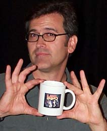 Bruce Campbell holding LnE mug